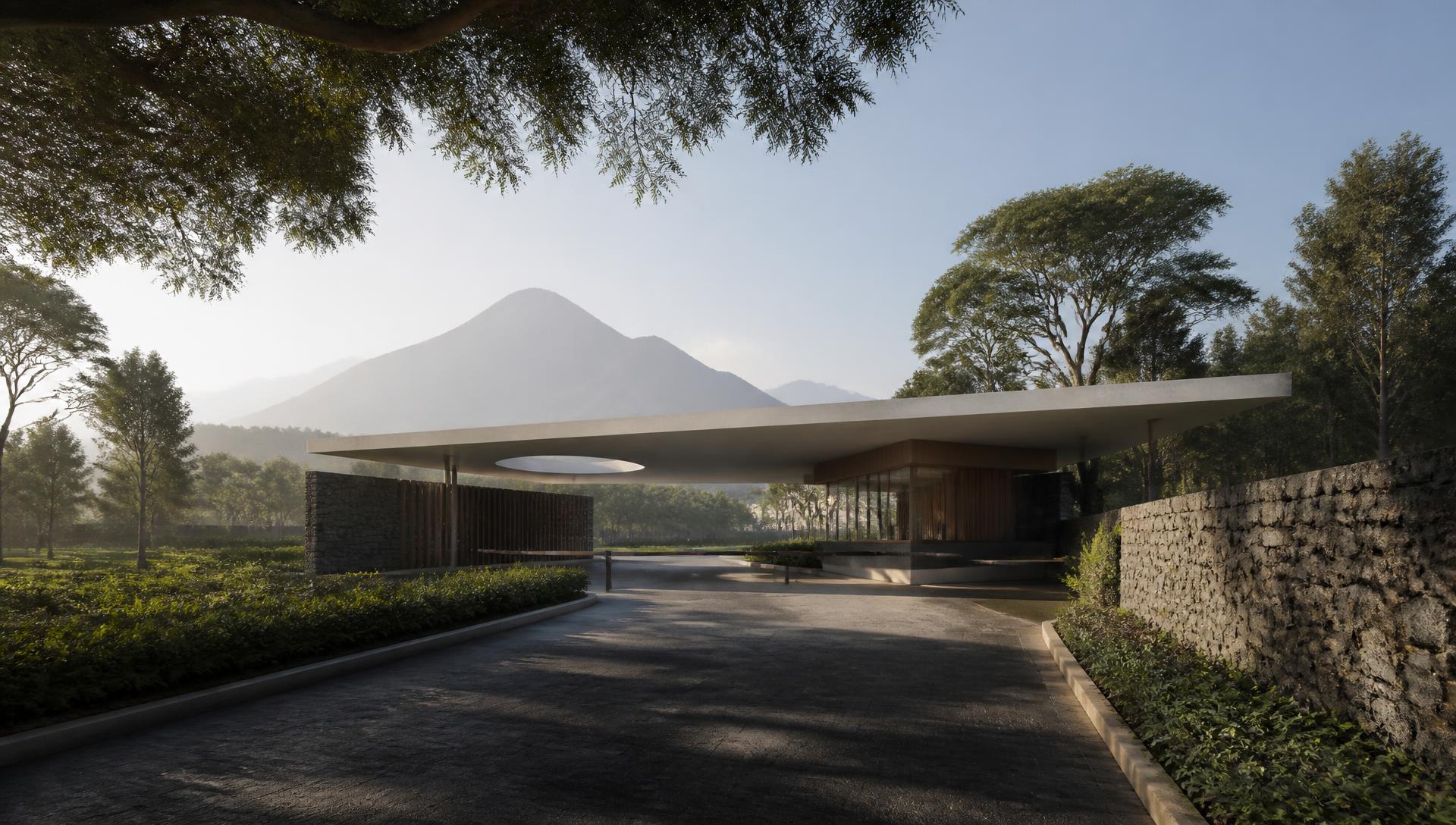 Campus entrance gatehouse with cantilevered canopy beneath the Virunga range